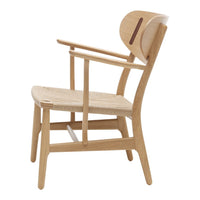 Light oak chair with a natural woven seat and minimalist design, featuring clean lines and subtle wood grain patterns.