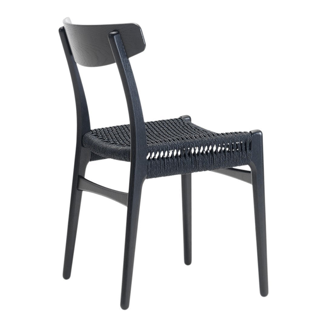 Black woven chair with a sleek design and contrasting textured seat, perfect for modern decor.