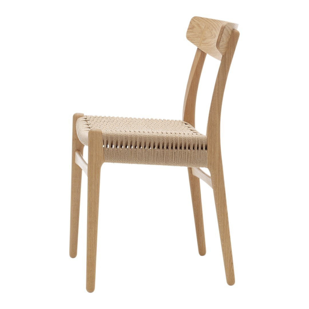Natural wood chair with light beige woven seat and backrest, featuring minimalist design and smooth curves.