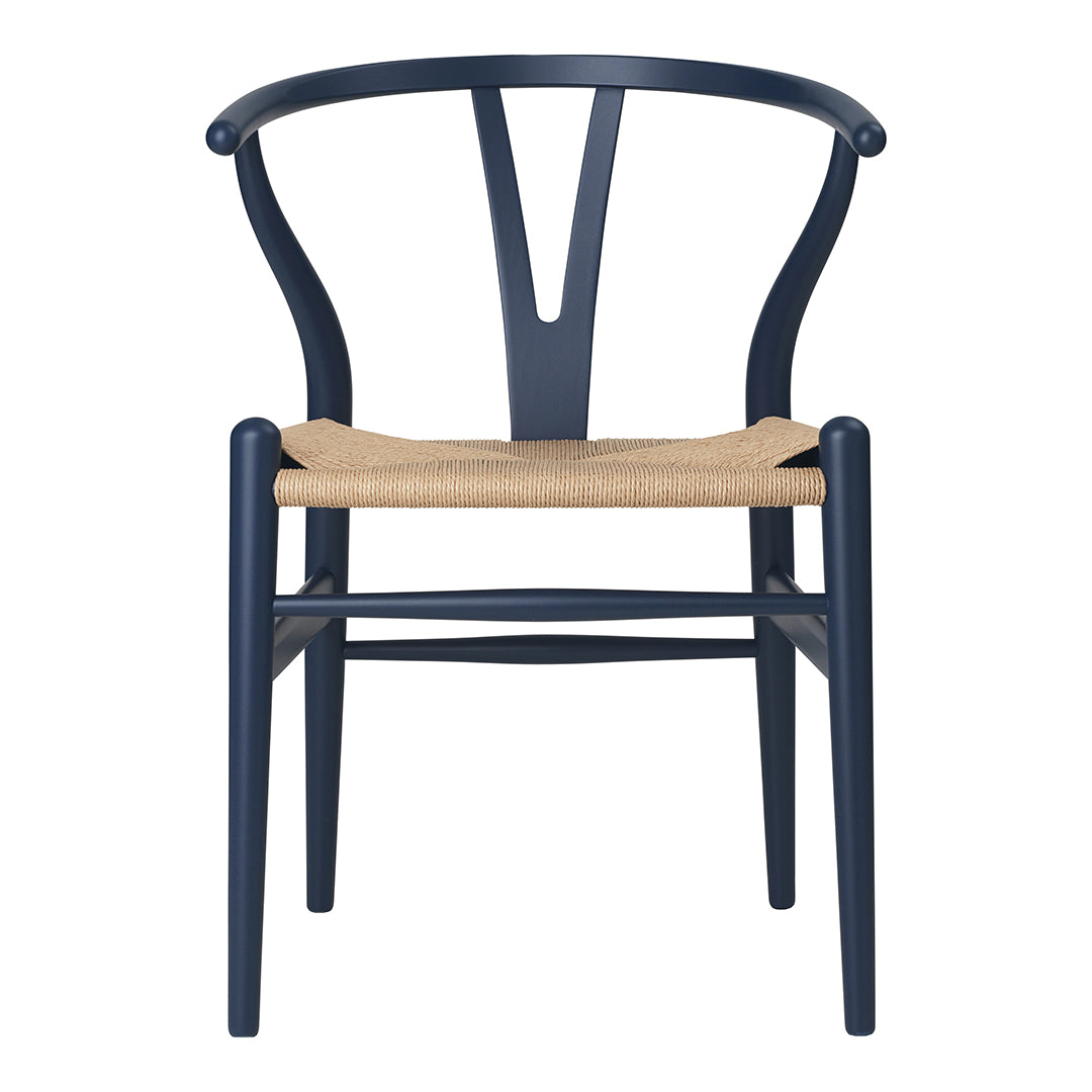 Navy blue chair with a minimalist design and natural woven seat. Elegant and modern home decor piece.