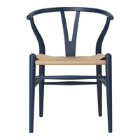 Navy blue chair with a minimalist design and natural woven seat. Elegant and modern home decor piece.