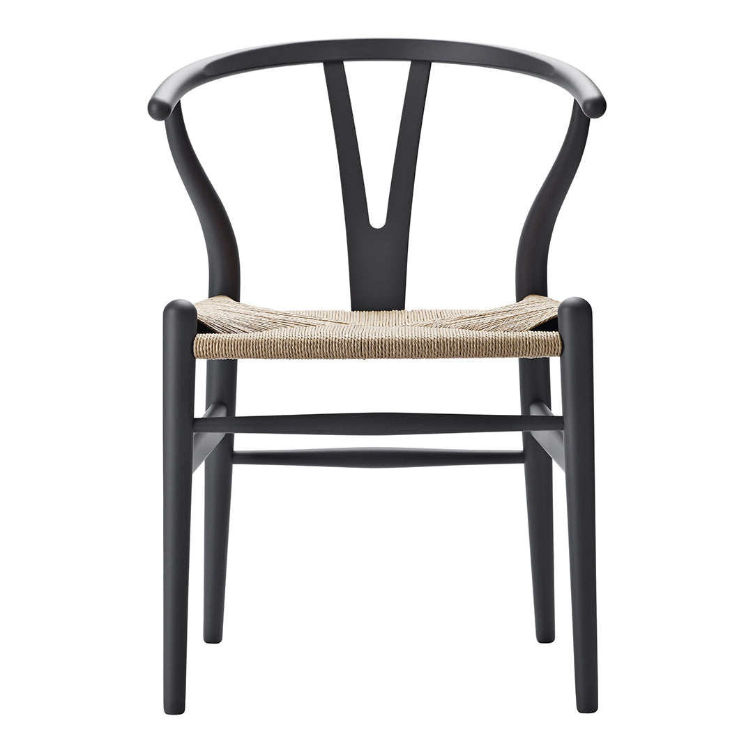 Black wooden chair with a woven natural fiber seat, featuring a minimalist design and smooth curves.