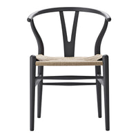 Black wooden chair with a woven natural fiber seat, featuring a minimalist design and smooth curves.