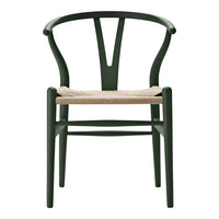 Green wooden chair with a minimalist design and natural woven seat, featuring clean lines and an elegant silhouette.