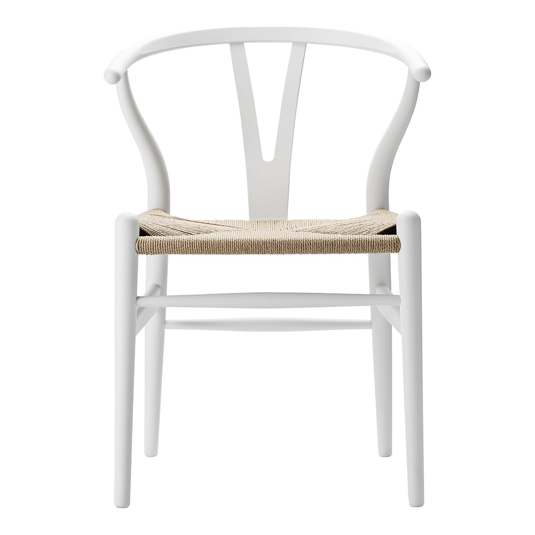 White wooden chair with a natural woven seat, featuring a minimalist design and elegant curves.