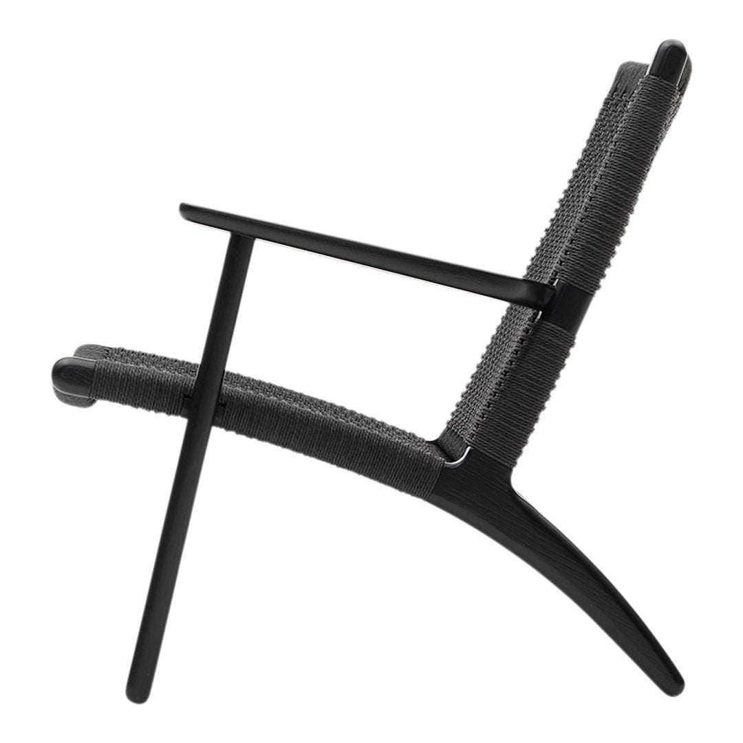 Black modern chair with a textured pattern, featuring sleek lines and a minimalist design. Ideal for contemporary spaces.