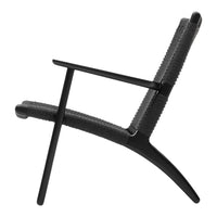 Black modern chair with a textured pattern, featuring sleek lines and a minimalist design. Ideal for contemporary spaces.