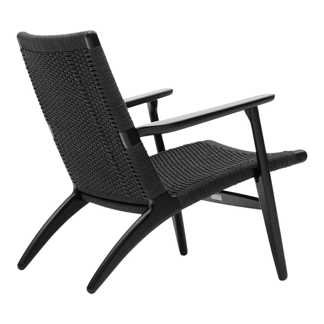Black woven chair with a minimalist design and smooth wooden armrests, featuring a contemporary geometric pattern.