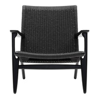 Black woven chair with a sleek design and contrasting light gray cushions, featuring a minimalist pattern.