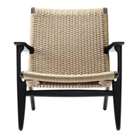 Natural beige woven seat with black wooden frame, showcasing a minimalistic design and modern aesthetic.
