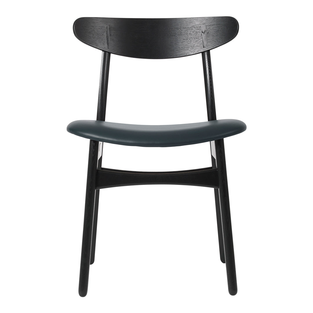 Black wooden chair with a smooth, dark green seat and simple, modern design. Elegant and minimalist style.