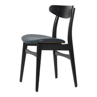 Black wooden chair with a smooth, dark blue upholstered seat and a minimalist design.
