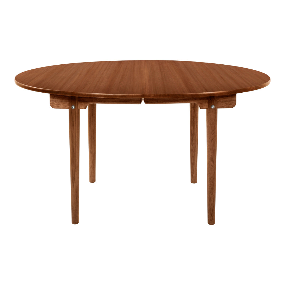 Round wooden table in warm walnut finish with a smooth, natural grain pattern. Ideal for modern dining spaces.