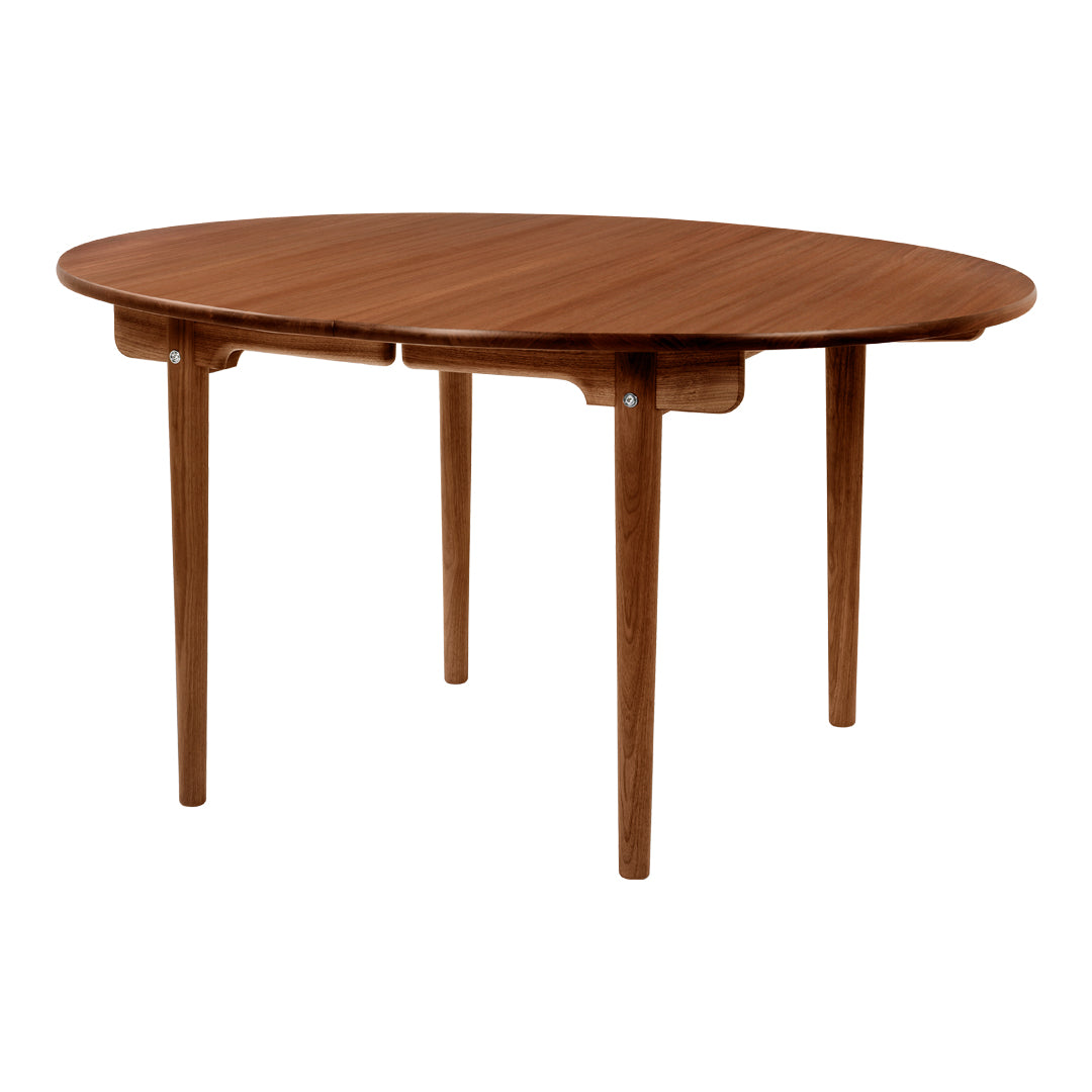 Round wooden dining table in a rich walnut finish with a sleek, minimalist design and tapered legs.
