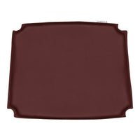 Deep burgundy silicone placemat with a smooth surface and elegant curved edges, ideal for dining settings.
