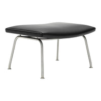 Black padded ottoman with sleek silver legs, featuring a smooth, minimalist design. Perfect for modern interiors.