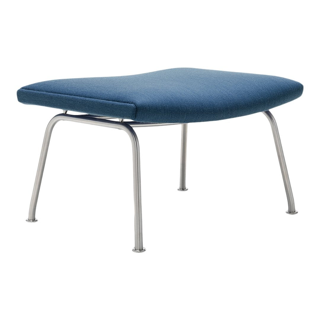 Blue upholstered ottoman with a sleek, minimalist design and silver metal legs.