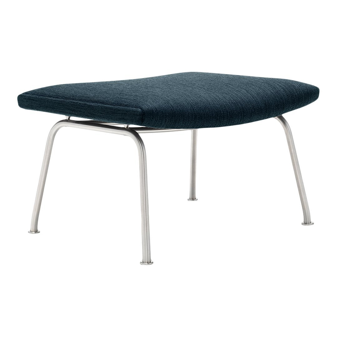 Textured dark blue ottoman with sleek silver metal legs, perfect for modern decor.
