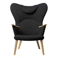 "Stylish black upholstered chair with a unique butterfly shape and wooden legs, perfect for modern decor."