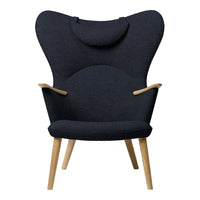 Dark navy blue upholstered armchair with a sleek, matte wood frame and elegant curved design. Perfect for modern decor.