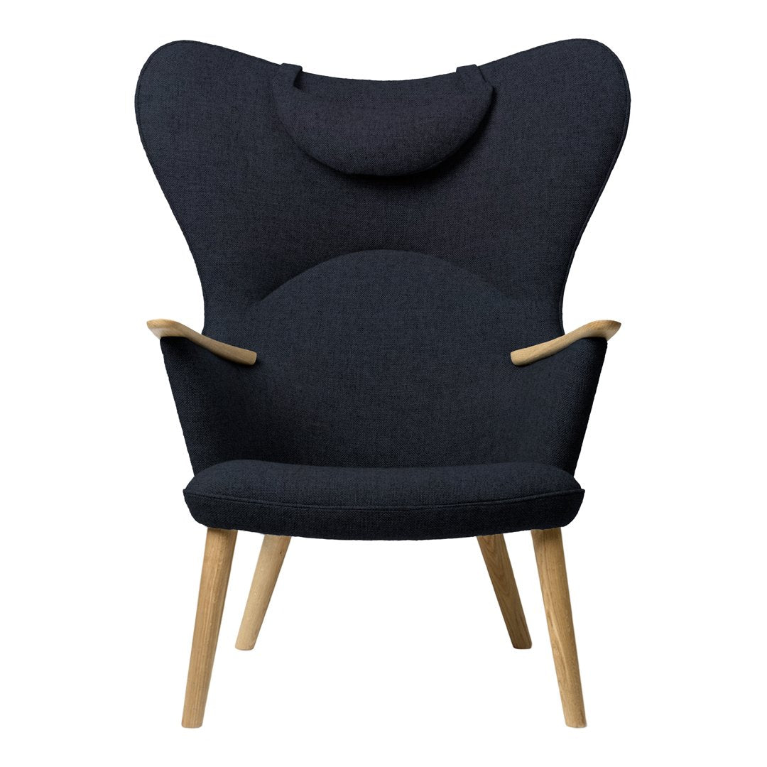 Stylish dark gray chair with organic shape and wooden legs, featuring a textured fabric pattern for a modern look.