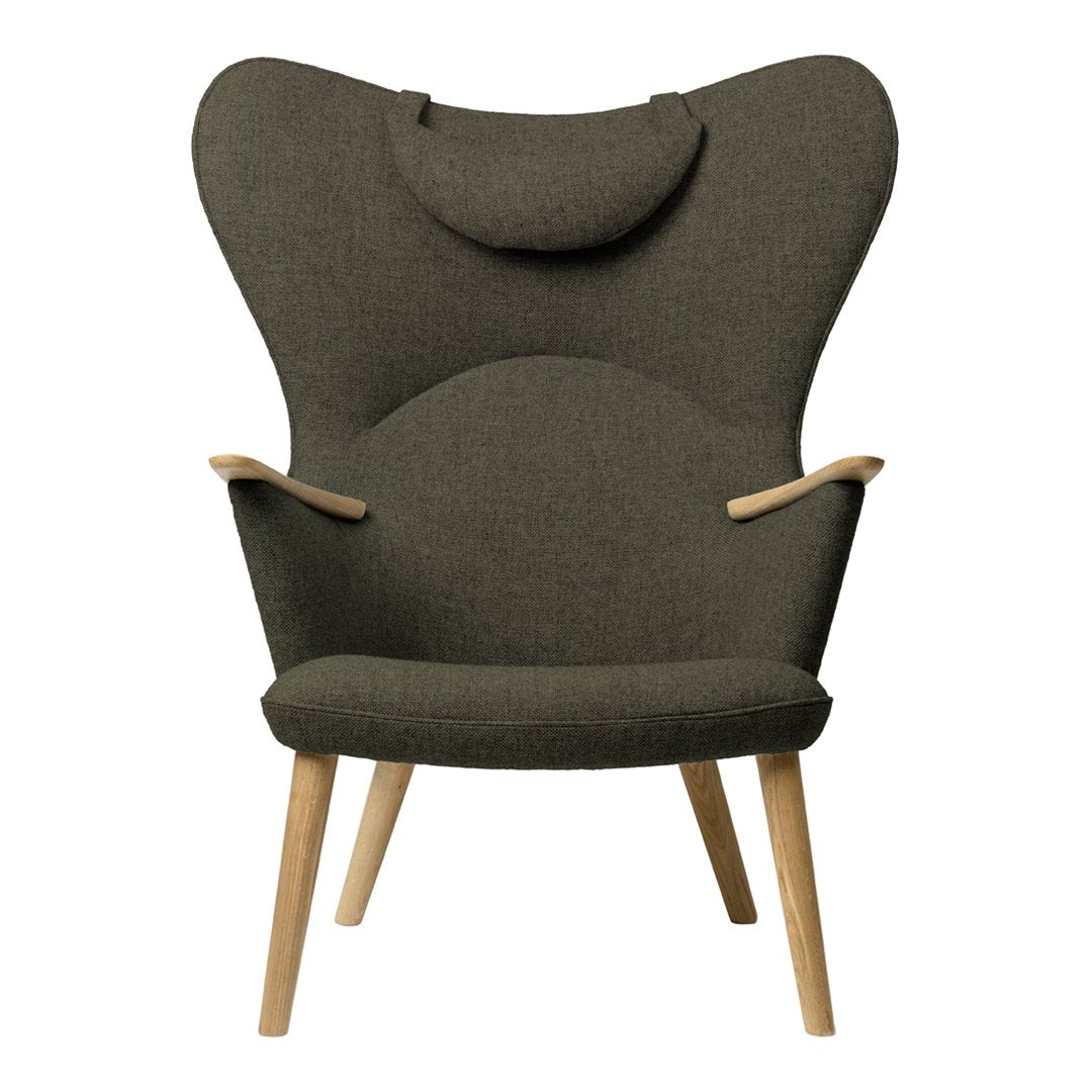 Dark olive green upholstered chair with a smooth, minimalist design and natural wood legs. Simple, modern patterns.