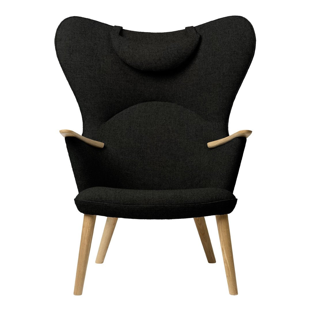 Stylish black armchair with a unique butterfly shape and wooden legs, featuring a textured fabric for added depth.