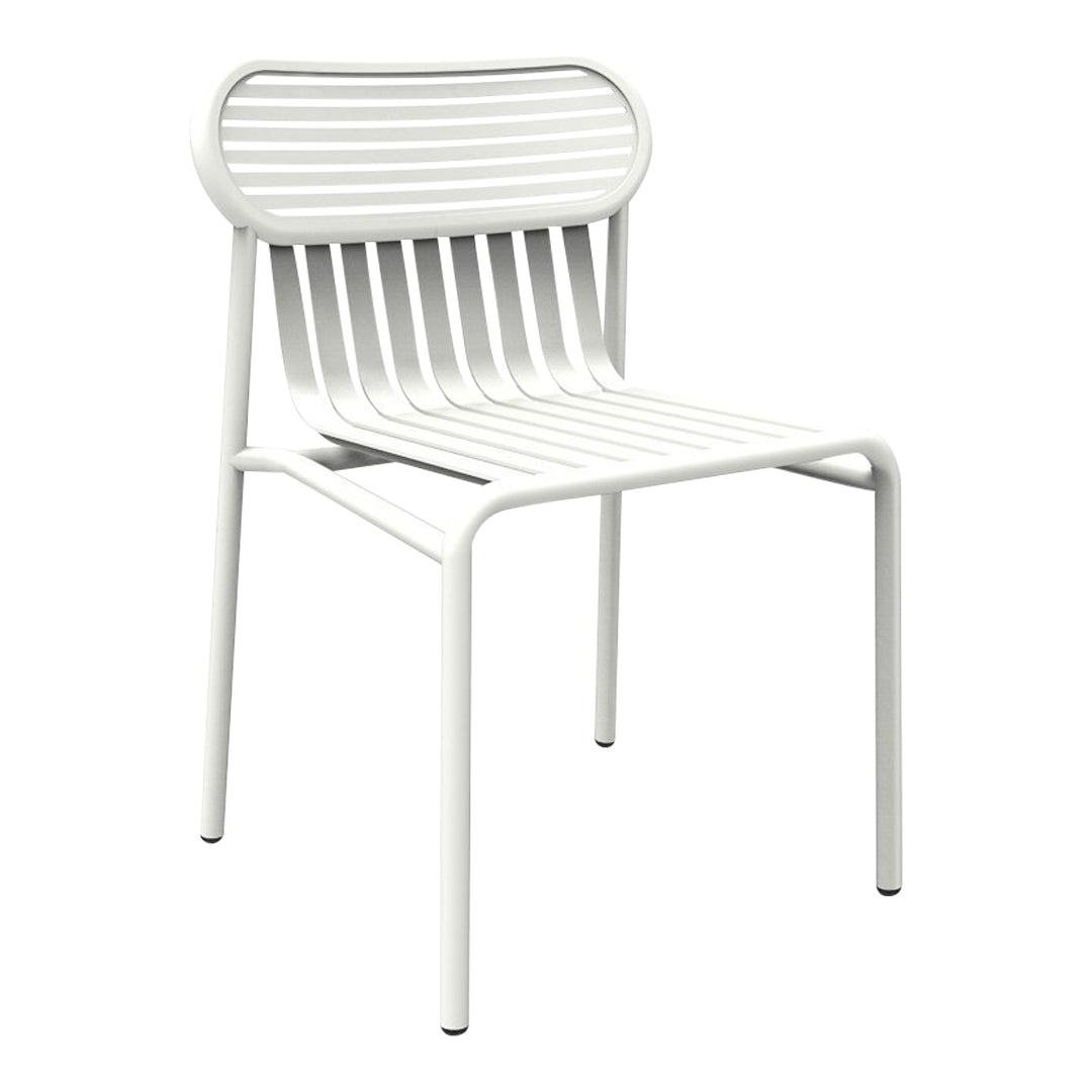 White chair with sleek slatted design, featuring minimalistic and modern lines for a clean aesthetic.