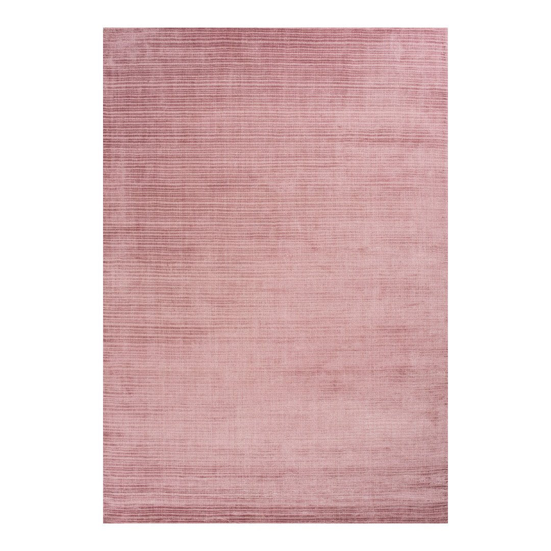 Solid blush pink area rug with subtle textured pattern, perfect for adding warmth and elegance to any space.