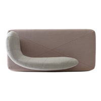 Modern sofa featuring a textured pink fabric with a curved gray accent pillow, creating a stylish and contemporary look.