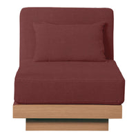 "Rust-colored chaise lounge with a sleek wooden base and matching throw pillow, featuring a solid fabric pattern."
