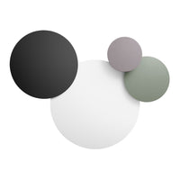 Colorful wall decor featuring black, white, soft pink, and muted green circular patterns. Stylish modern design.
