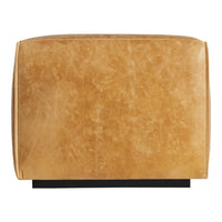 Tan leather pouf with a soft, textured finish and a solid black base. Ideal for modern decor.
