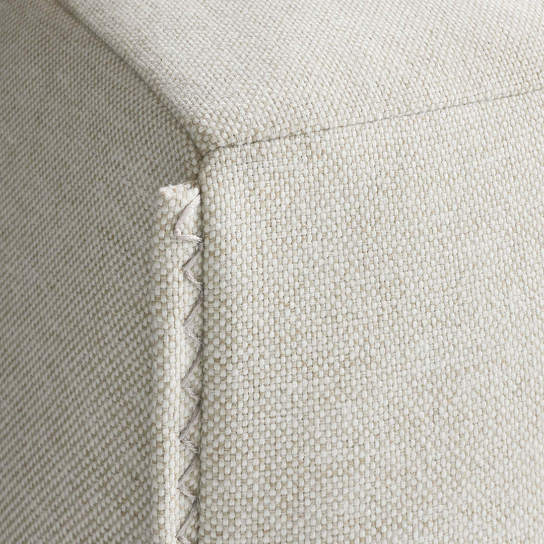 Beige textured fabric with subtle stitching detail. Ideal for modern home decor.