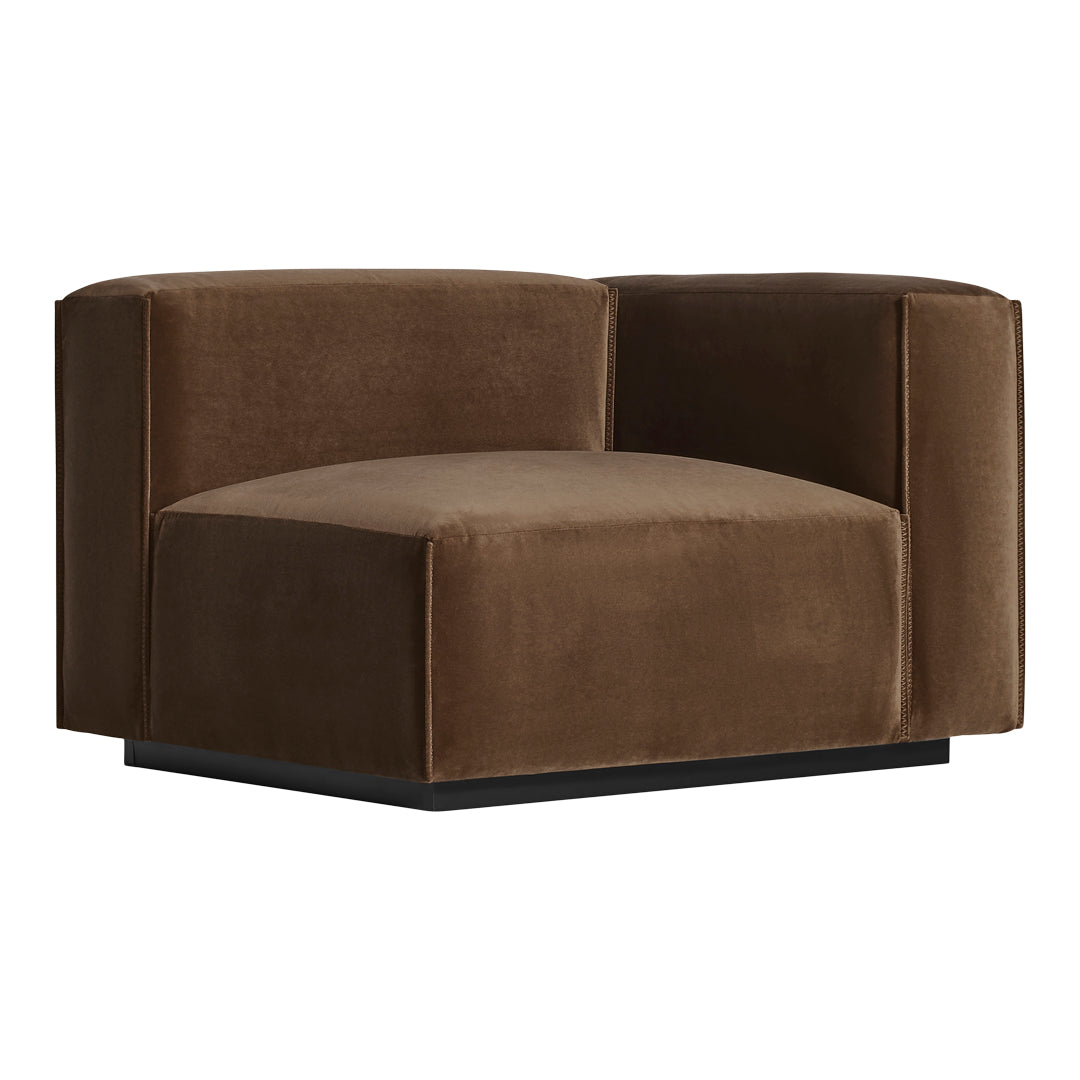 Brown velvet accent chair with a minimalist design and smooth texture, featuring a sleek black base.