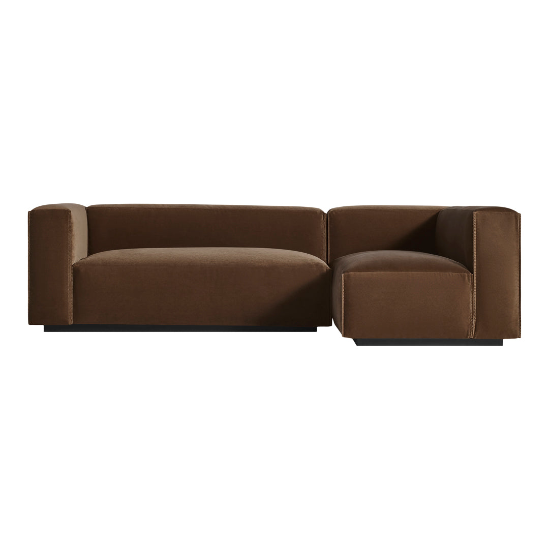 Brown velvet sofa with clean lines and a modern design, featuring a textured, plush surface for added comfort.