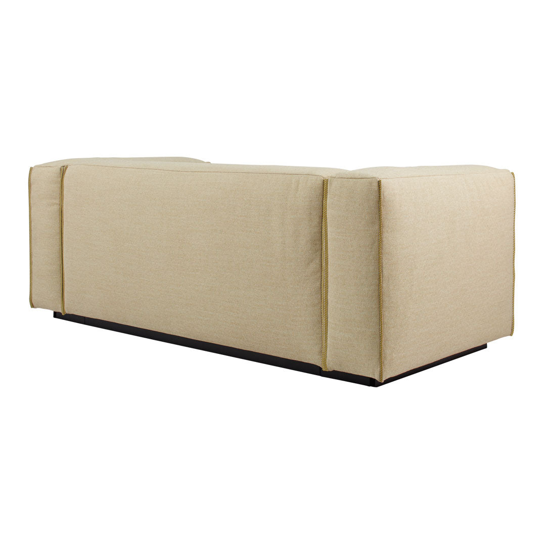 Beige block sofa with a smooth, solid texture and minimalistic design, featuring clean lines and a dark base.