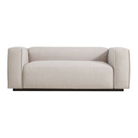 Cream-colored upholstered sofa with smooth, minimalist design and rounded armrests on a sleek black base.