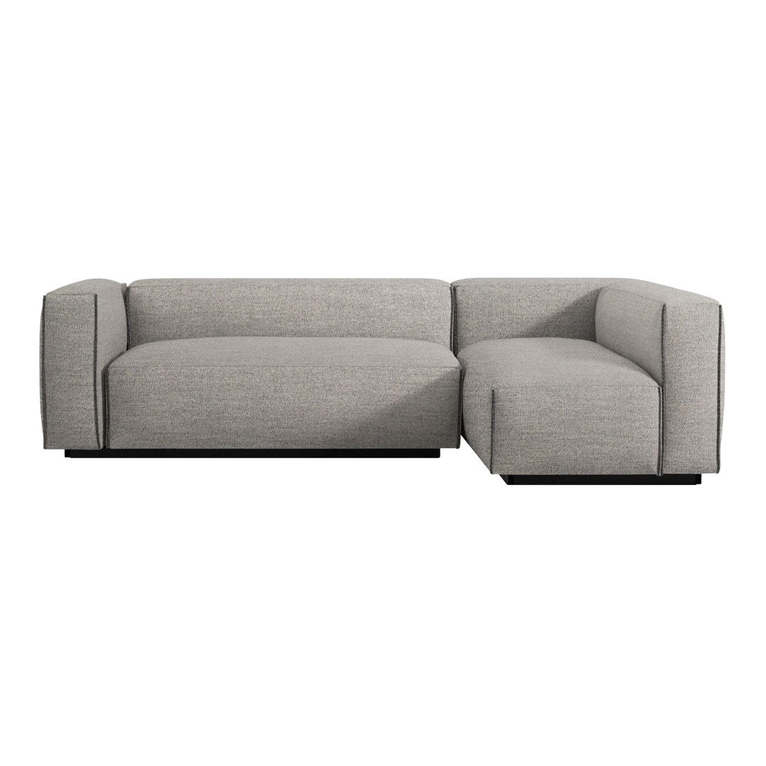 Gray sectional sofa with a sleek, modern design and textured fabric, featuring a minimalist pattern and clean lines.