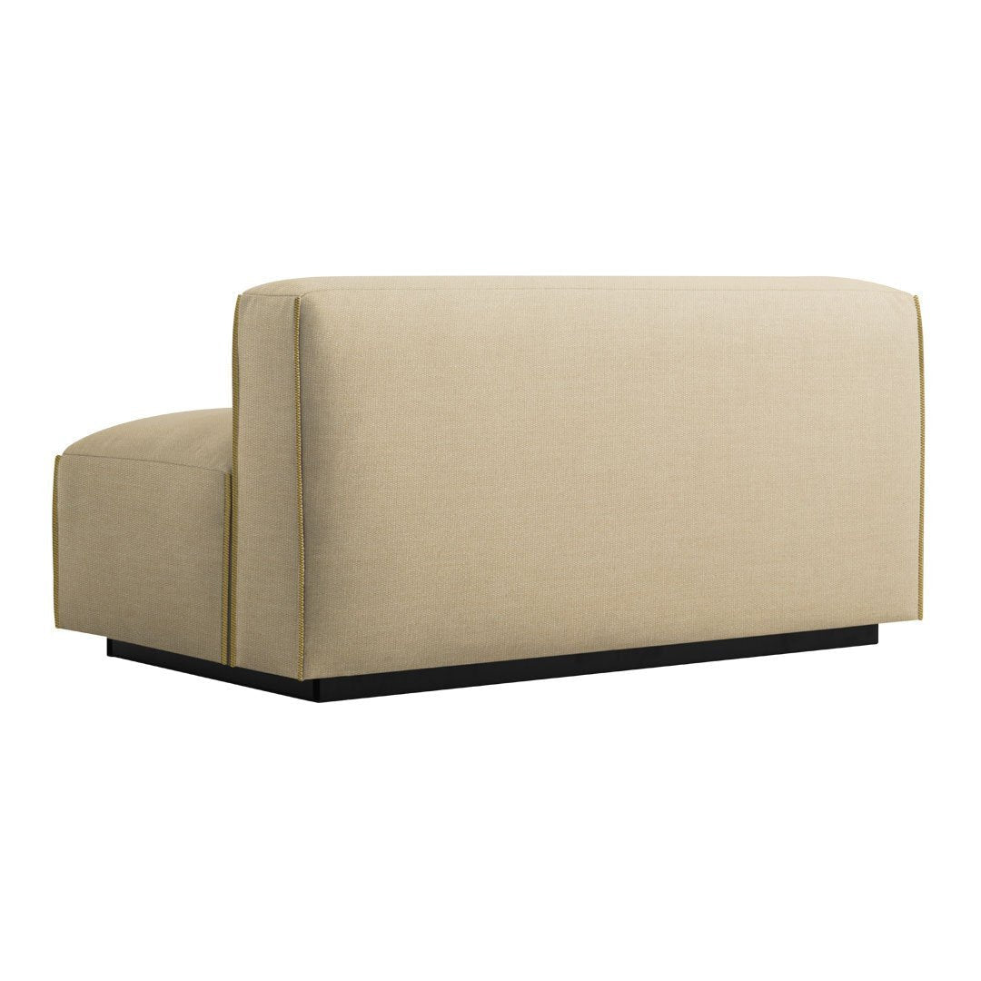 Beige upholstered sofa section with clean lines and a modern black base, perfect for contemporary decor.