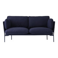 Navy blue upholstered sofa with soft, plush cushions and sleek metal legs. Modern design, minimalist aesthetic.