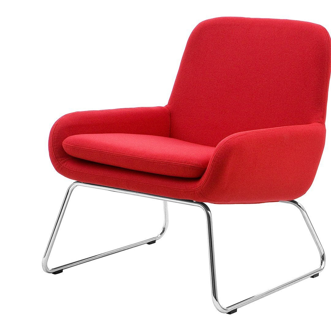 Bright red upholstered armchair with a minimalist design and sleek chrome legs, perfect for modern decor.