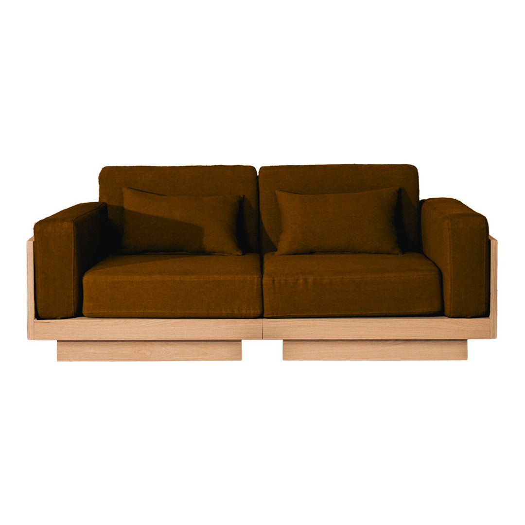 Stylish brown sofa with simple lines and plush cushions, featuring a minimalist wooden base. Perfect for modern decor.