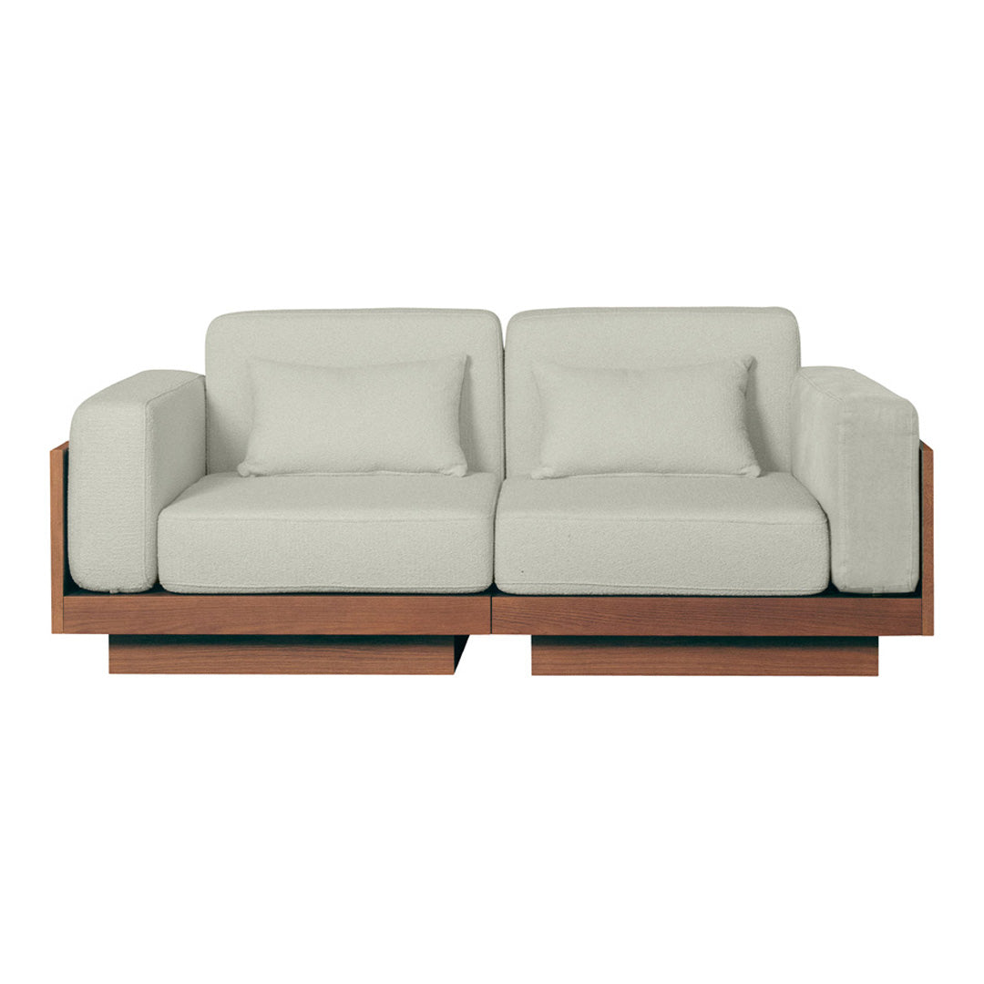 Light gray couch with a minimalist design and dark wooden accents, featuring a modern, clean aesthetic.