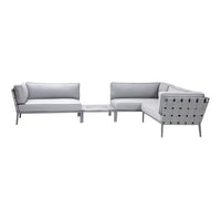 Modern L-shaped sofa set in soft gray fabric with sleek silver accents and minimalist geometric patterns.