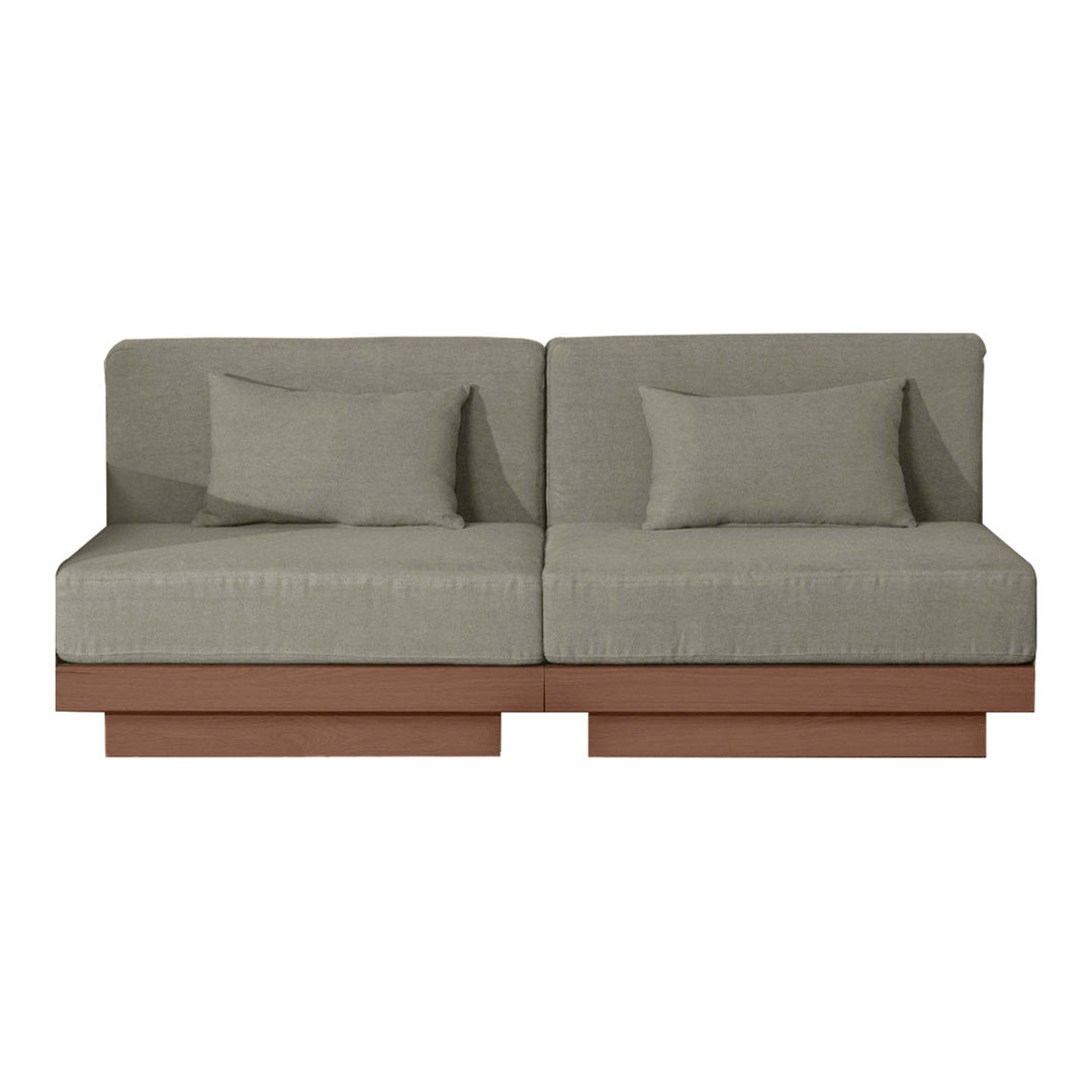 Gray upholstered sofa with two plush pillows and a smooth, warm-toned wooden base for a modern look.