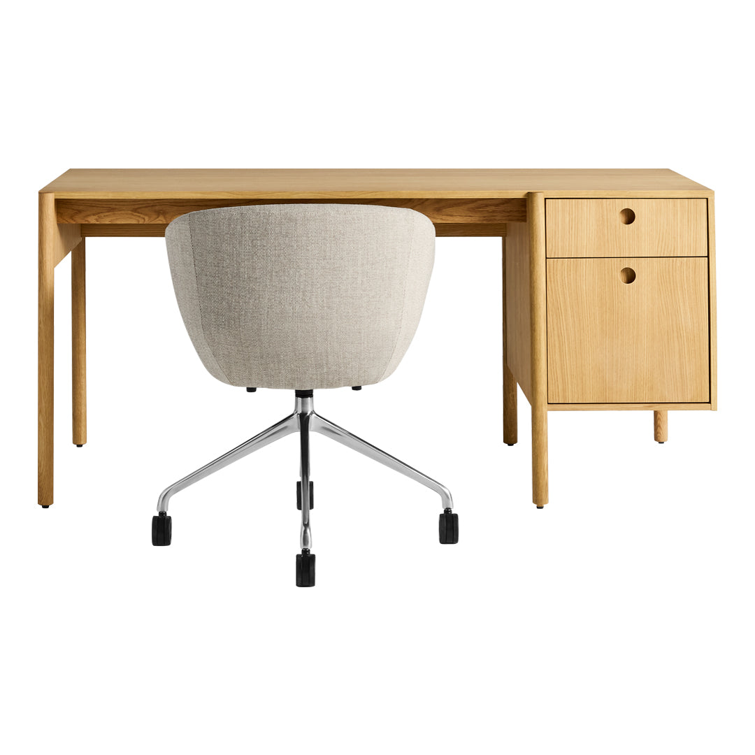 Modern oak desk with light wood finish, paired with a soft beige upholstered chair and sleek chrome accents.