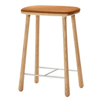 Tan padded seat with natural wood legs and metallic footrest, showcasing a minimalist, modern design.