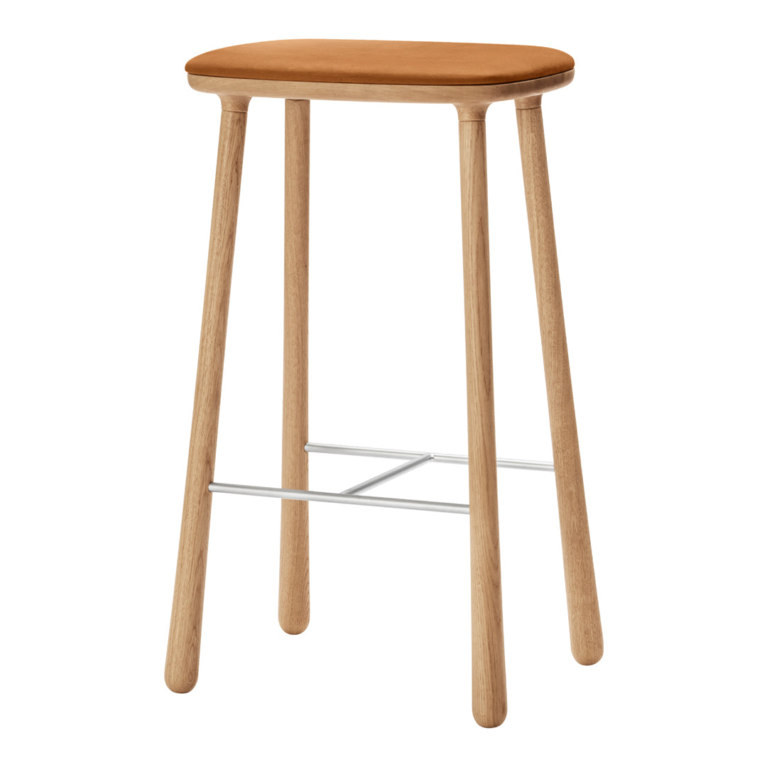 Natural wood bar stool with a smooth tan seat and slender light-colored legs, featuring a silver footrest.