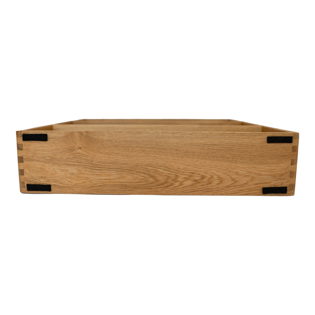 Light brown wooden crate with a natural grain pattern, featuring black accents at corners. Ideal for decor or storage.